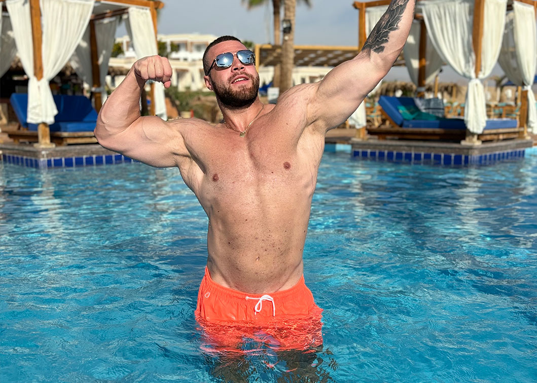 Coach posing in an outside pool
